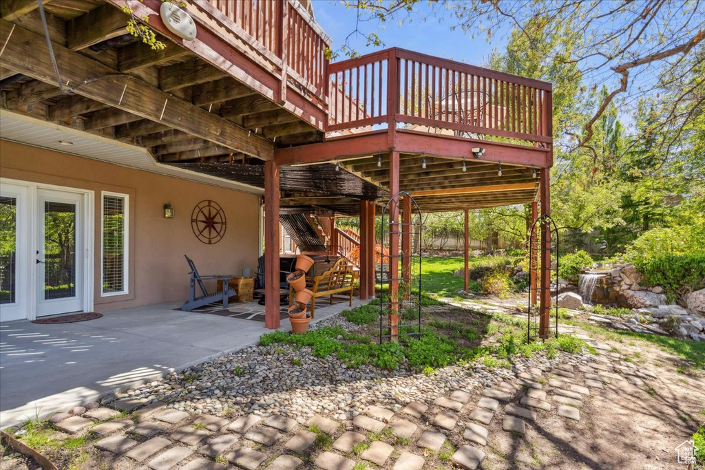 View of patio with a wooden deck