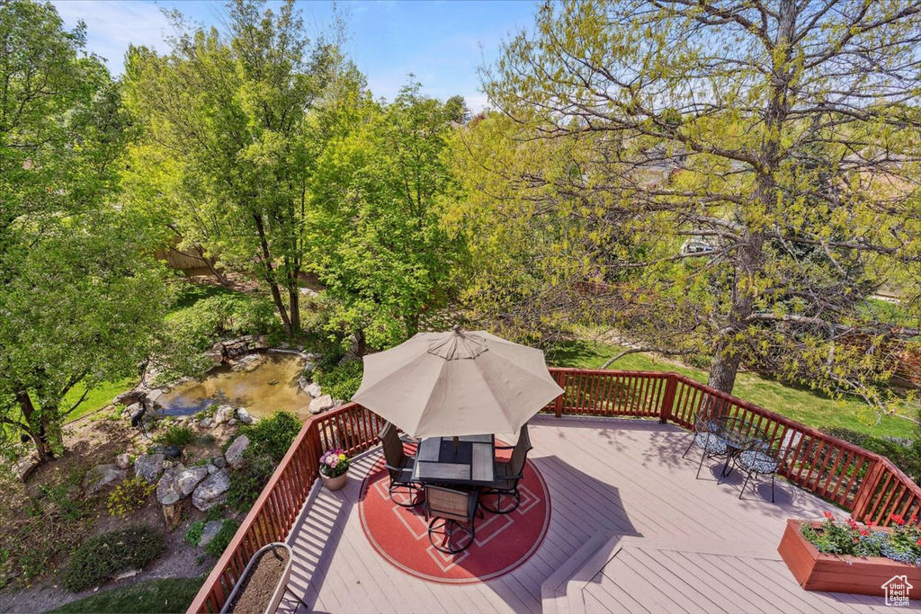 Wooden terrace featuring outdoor dining area