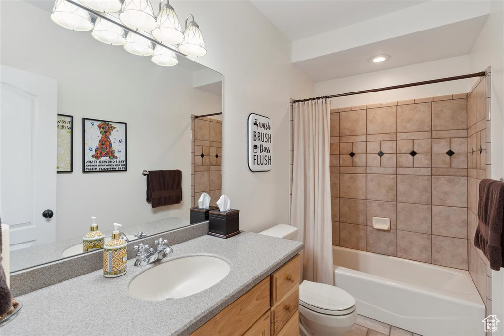 Full bath featuring vanity, toilet, and shower / tub combo