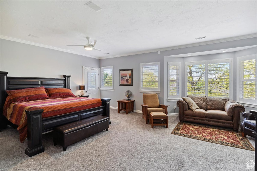 Bedroom featuring carpet, ornamental molding, baseboards, and ceiling fan