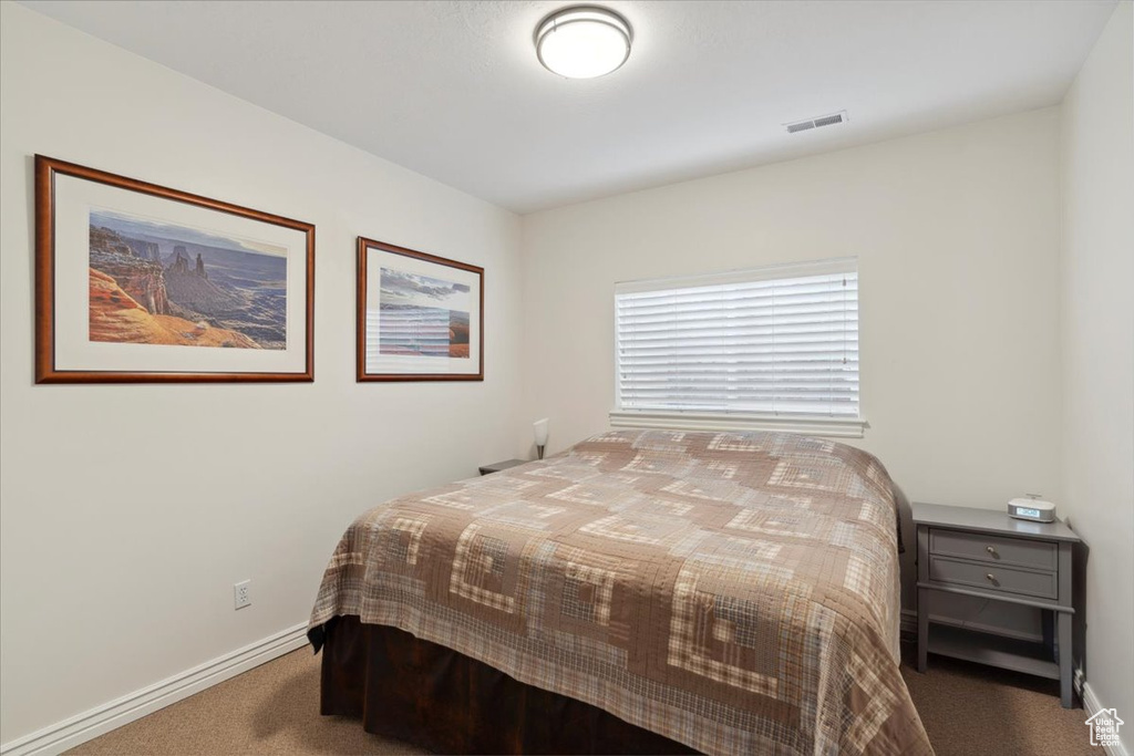Bedroom with carpet flooring and baseboards