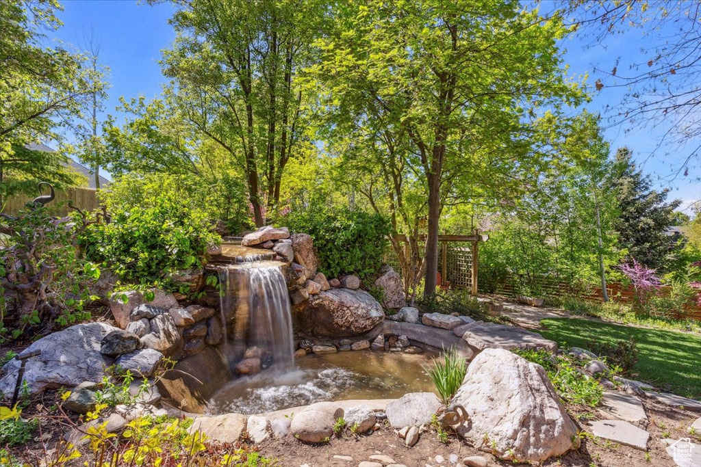 View of yard with a garden pond