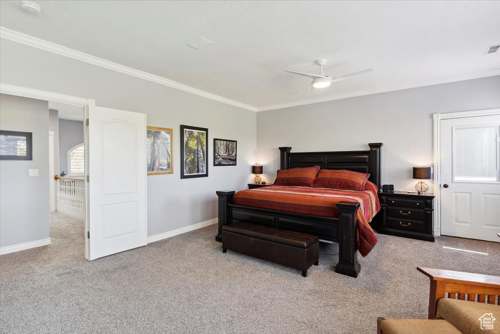 Carpeted bedroom with crown molding, baseboards, and a ceiling fan
