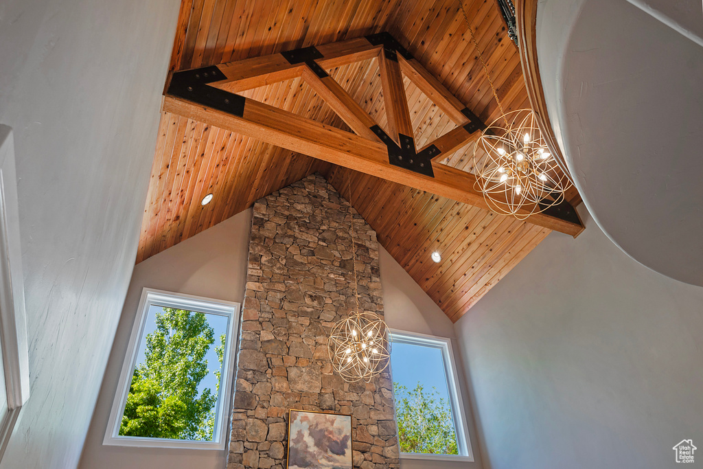 Detailed view of a chandelier and wooden ceiling with exposed beams