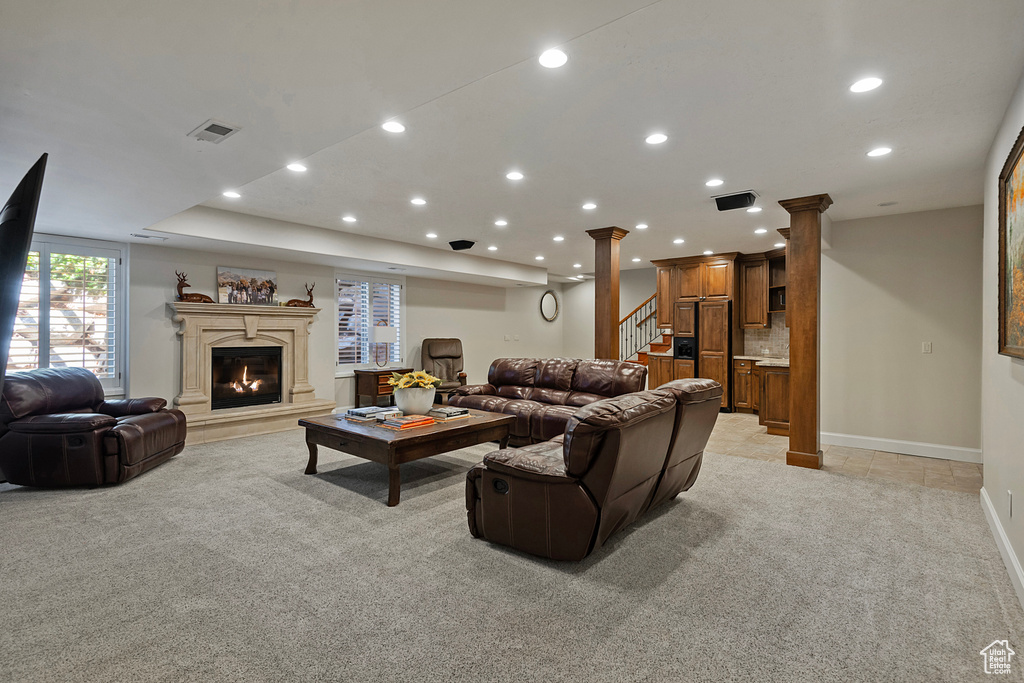 Living area with light colored carpet, recessed lighting, a fireplace, stairway, and baseboards