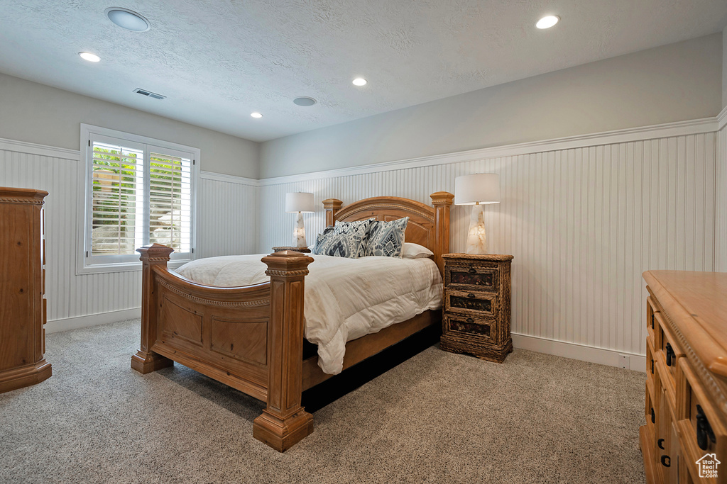 Bedroom featuring carpet, wainscoting, and recessed lighting