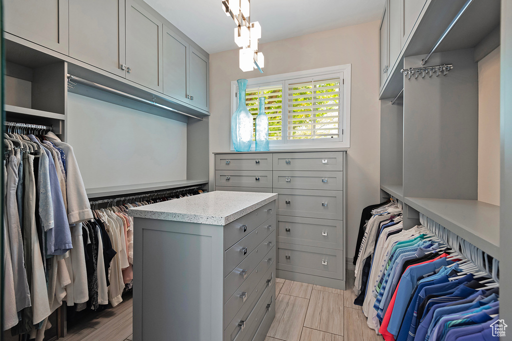 Spacious closet featuring a chandelier