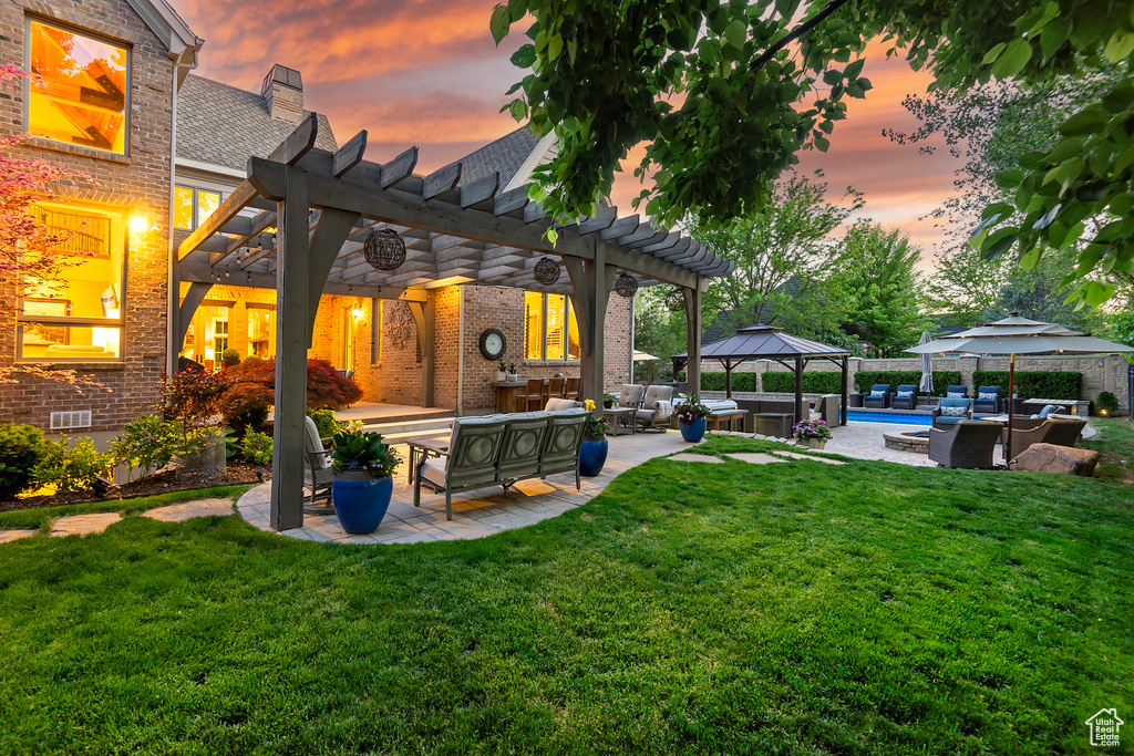 View of green lawn with an outdoor hangout area, a gazebo, a pergola, a patio area, and a jacuzzi