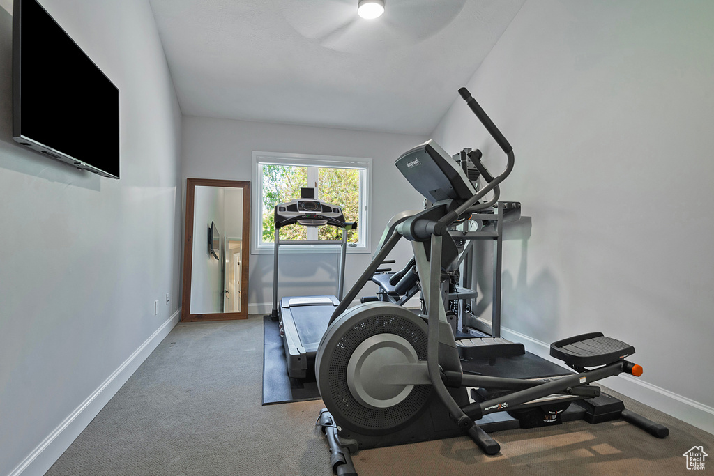 Exercise room featuring carpet and baseboards