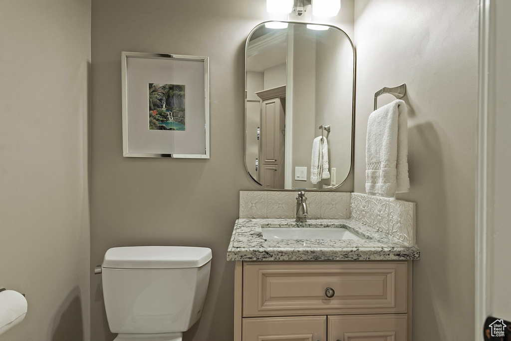 Half bathroom with toilet and vanity