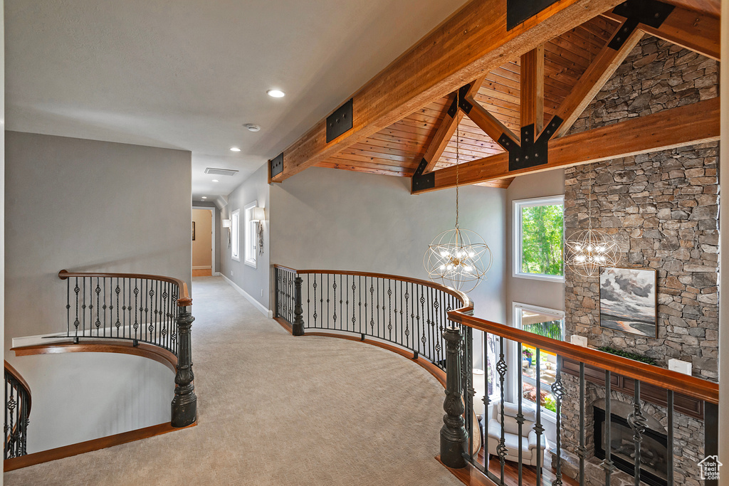 Hallway featuring an upstairs landing, carpet floors, a chandelier, baseboards, and recessed lighting