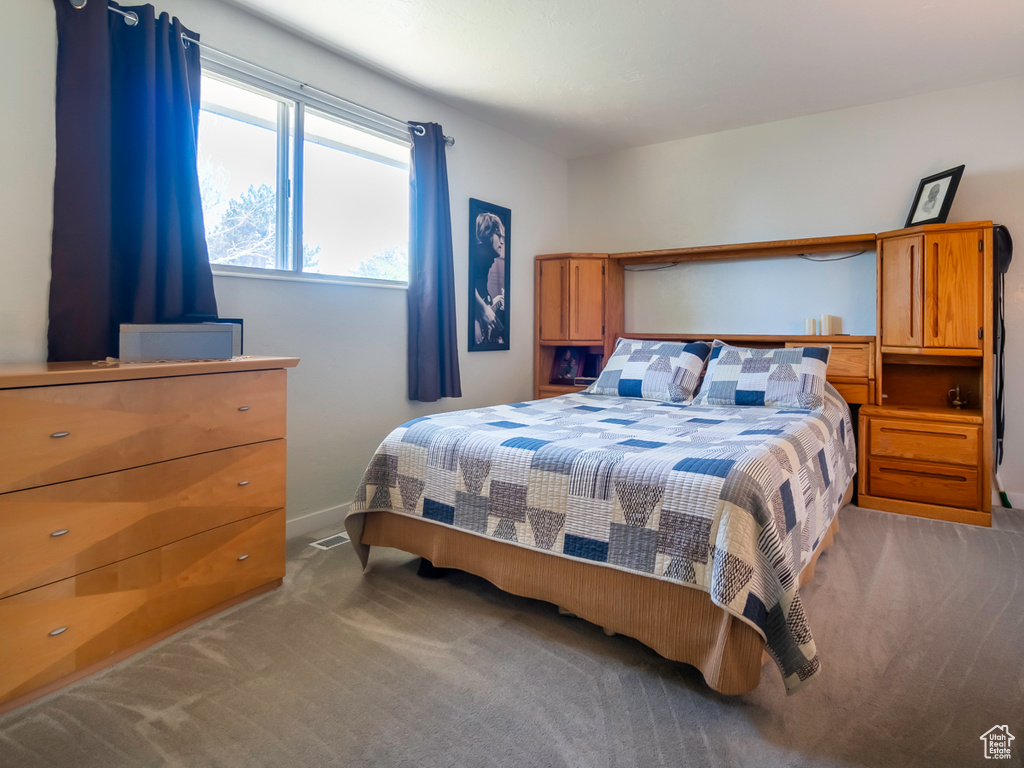 Carpeted bedroom featuring baseboards