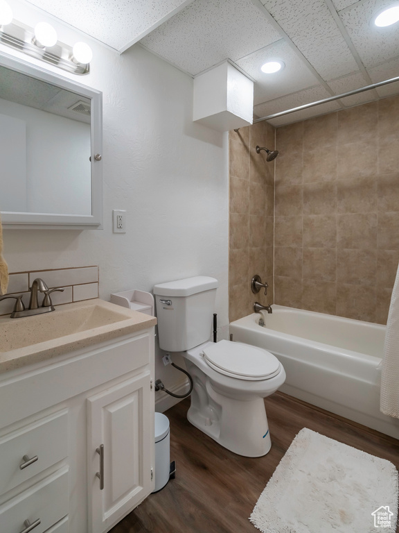 Full bathroom featuring toilet, wood finished floors, shower / bathtub combination, vanity, and recessed lighting