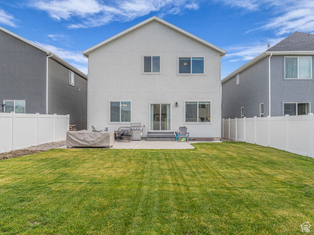 Back of property featuring stucco siding and a patio