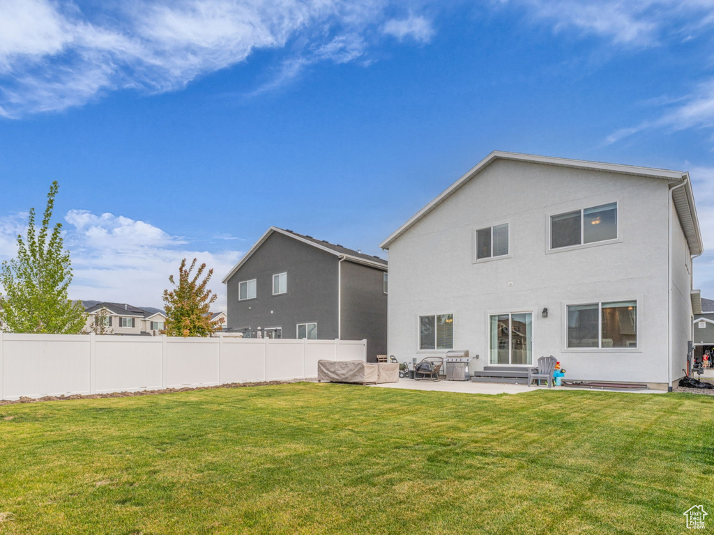 Back of house featuring a patio area and stucco siding