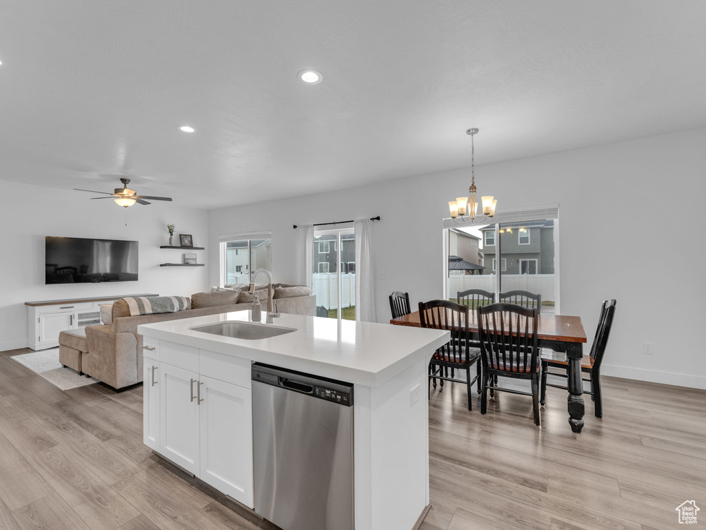 Kitchen with dishwasher, a sink, light wood-style floors, white cabinets, and a ceiling fan