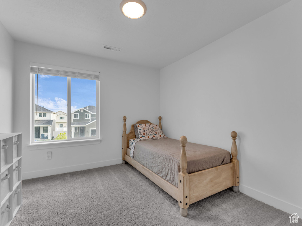 Carpeted bedroom featuring baseboards