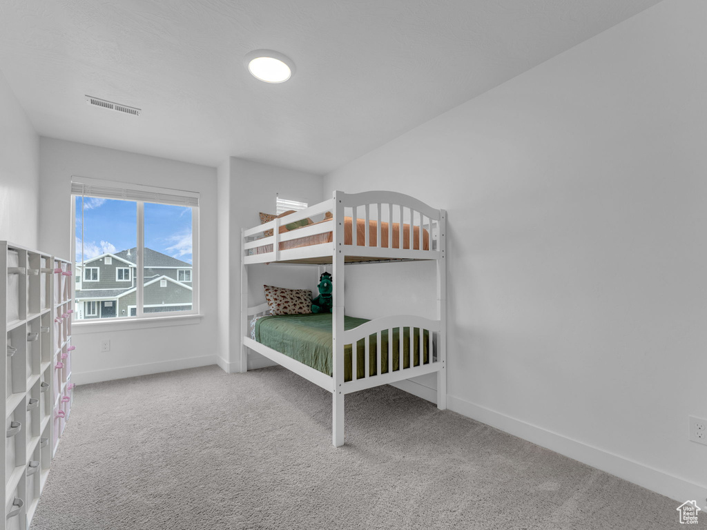 Unfurnished bedroom with carpet floors and baseboards