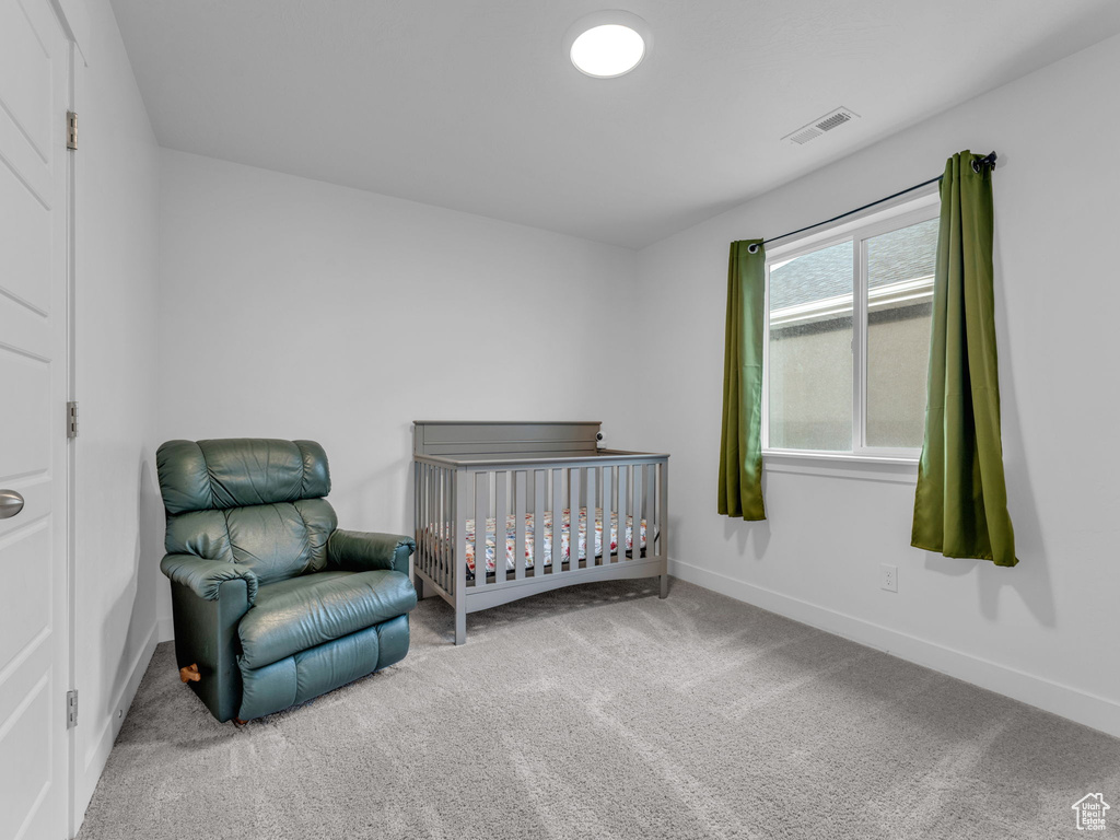 Carpeted bedroom featuring baseboards