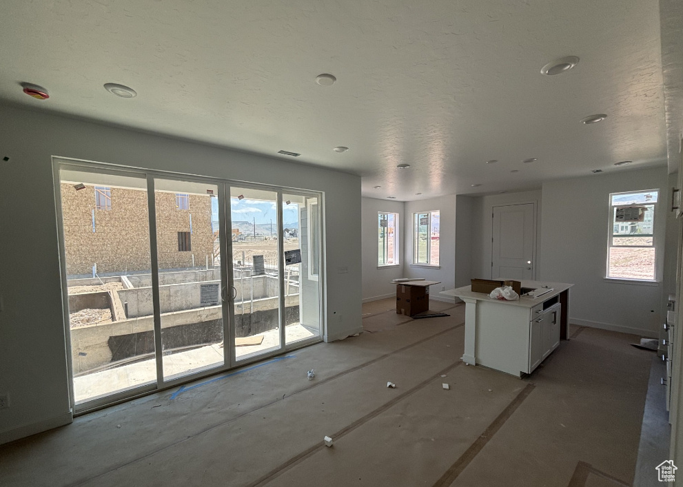 Kitchen featuring a kitchen island and white cabinetry