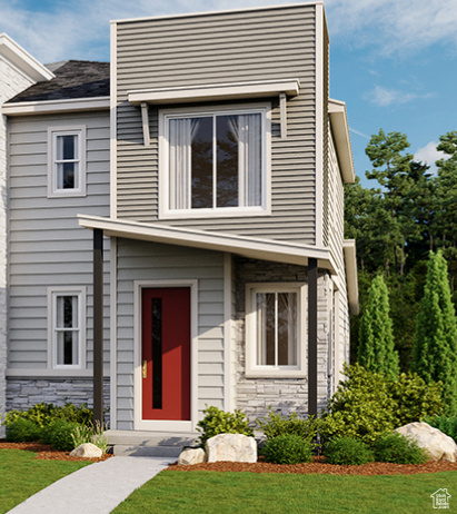 View of front of property with a front lawn and stone siding