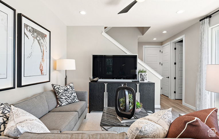 Living room with stairway, wood finished floors, recessed lighting, and ceiling fan