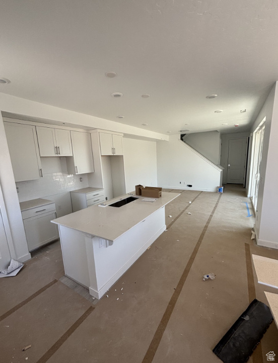 Kitchen with white cabinets and a center island