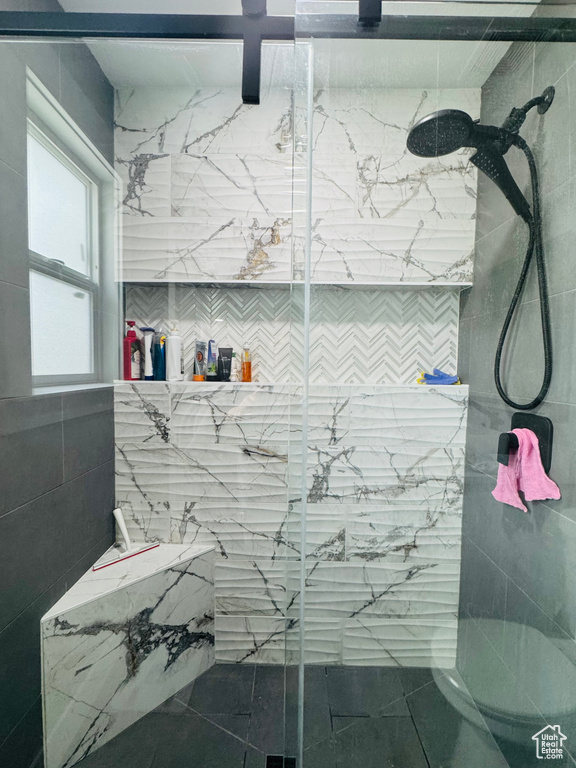 Full bathroom featuring a marble finish shower