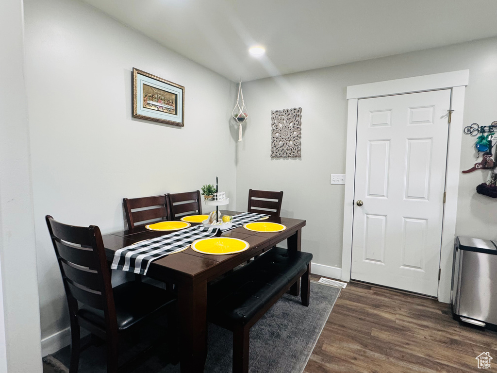 Dining area featuring dark wood-style flooring, recessed lighting, and baseboards