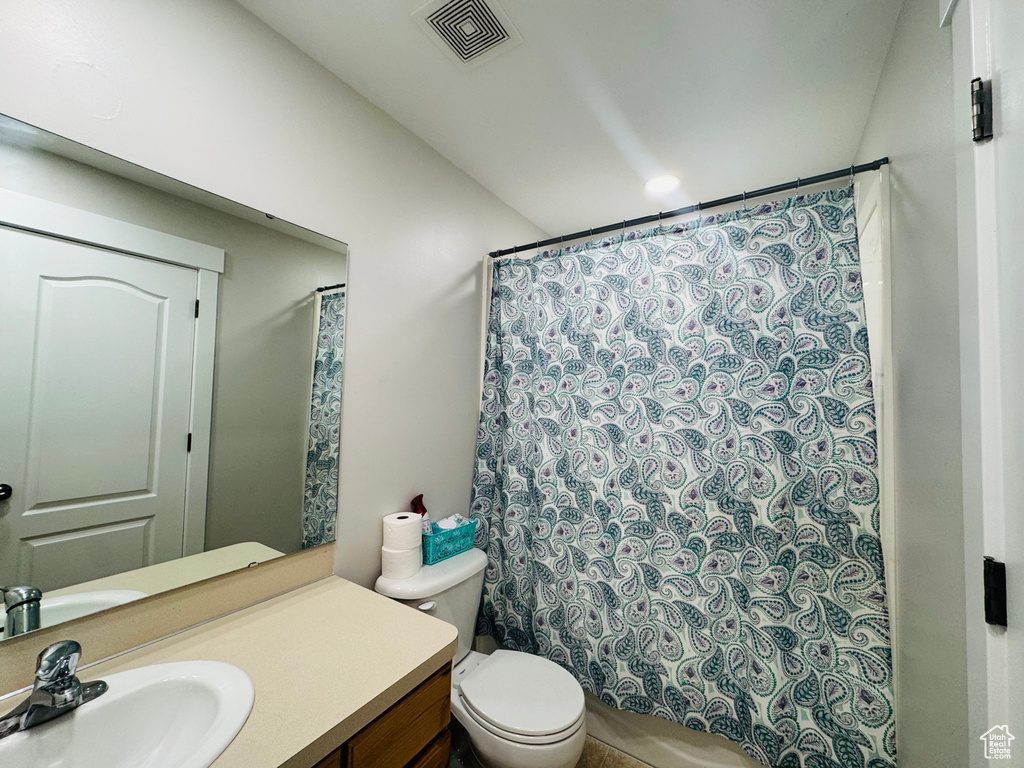 Full bath featuring vanity and toilet