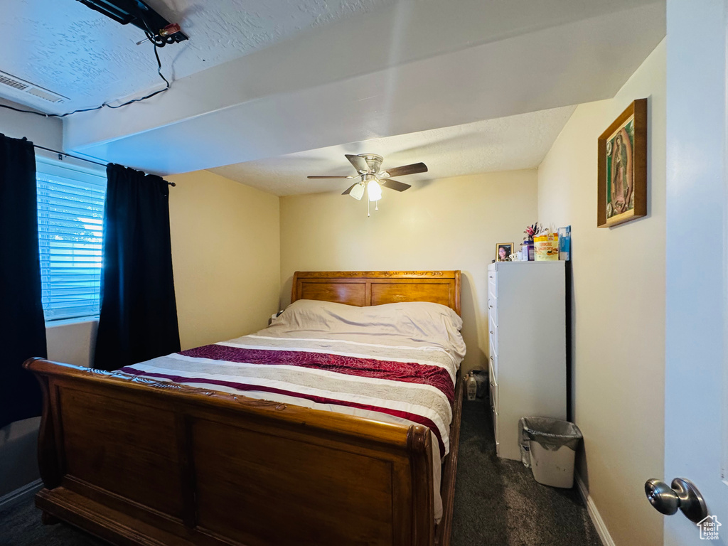 Bedroom featuring carpet, baseboards, and a ceiling fan