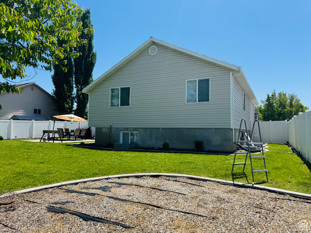 Rear view of property featuring a patio and central AC
