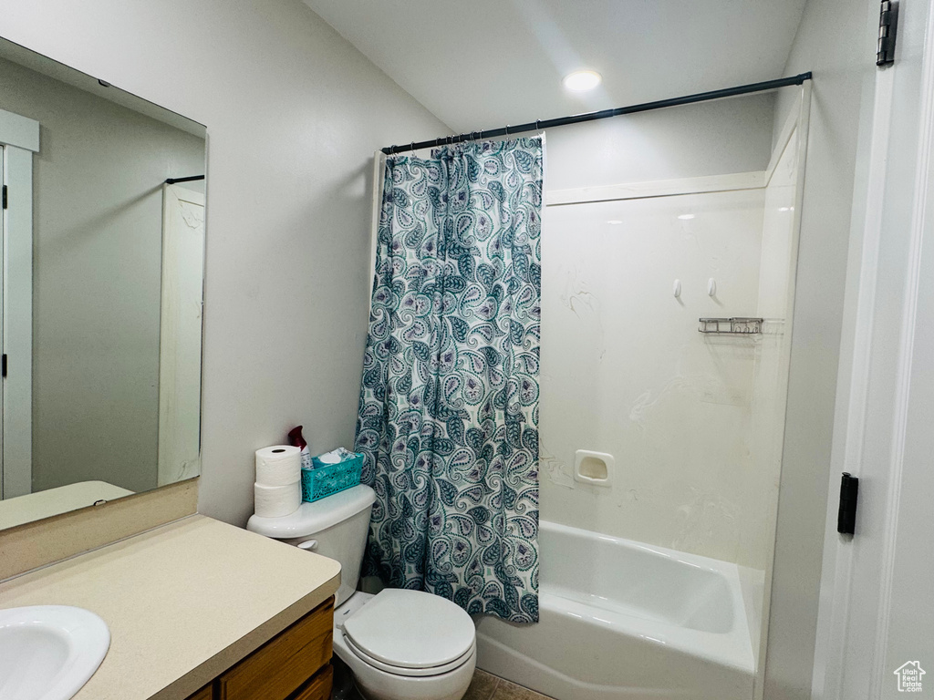 Full bathroom with vanity, shower / bathtub combination with curtain, and toilet