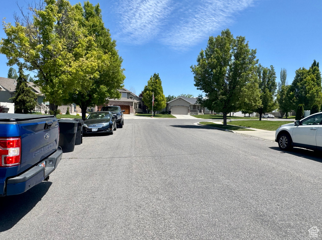 View of asphalt street with a residential view and sidewalks