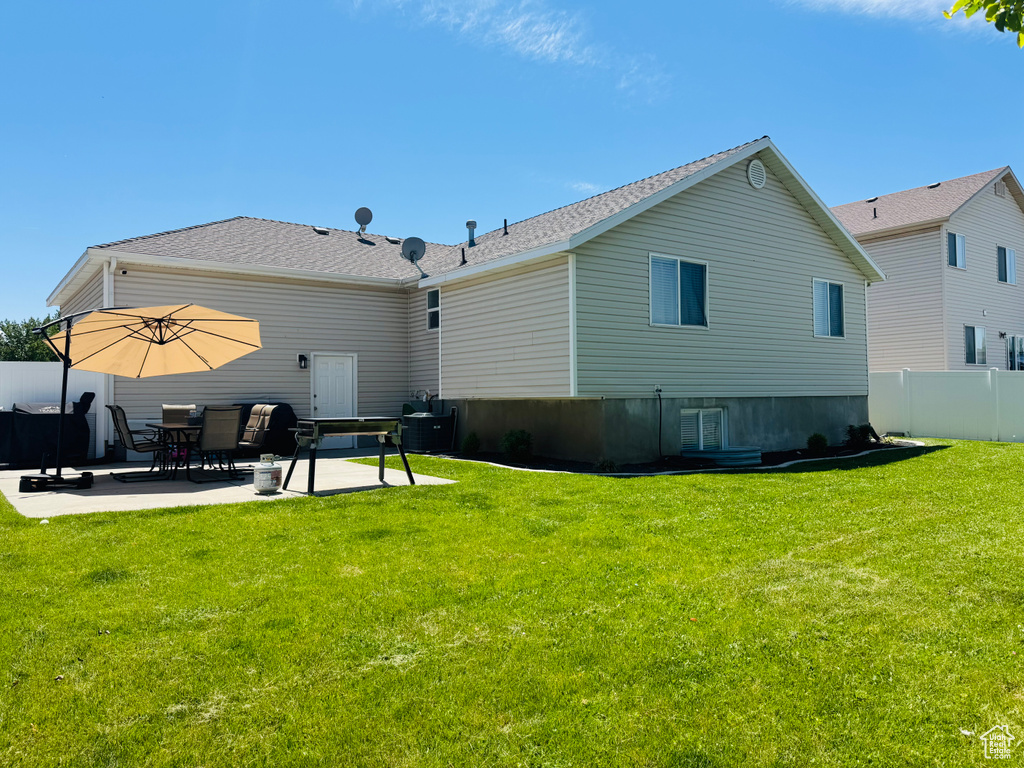 Back of house with a patio