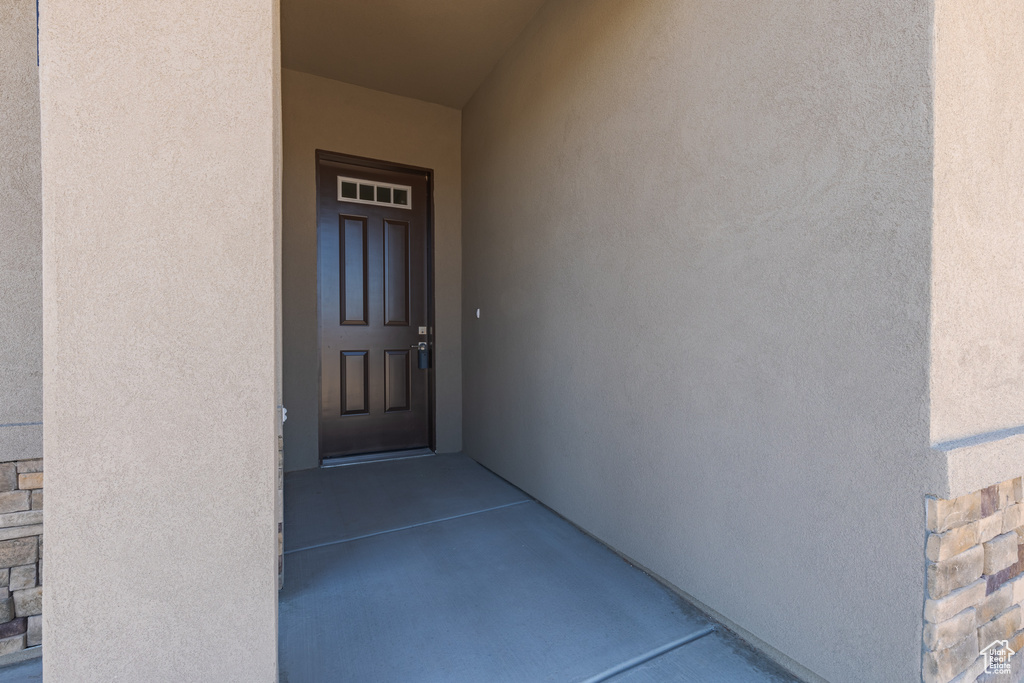 View of exterior entry featuring stucco siding