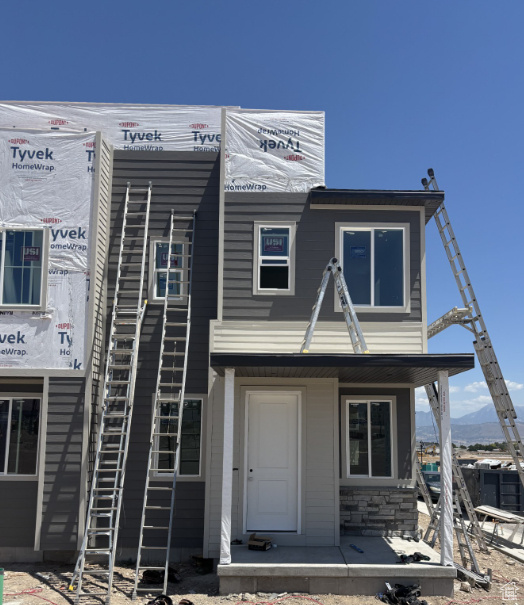 Multi unit property featuring covered porch and a mountain view