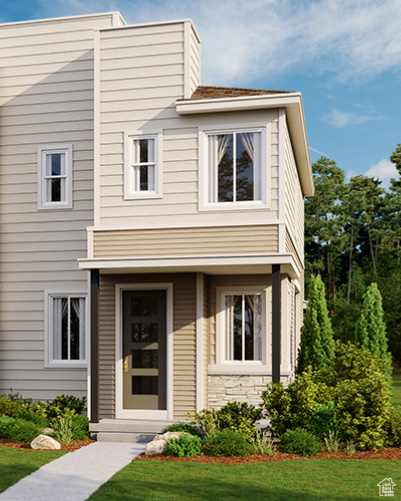 View of front of home with a front lawn and stone siding