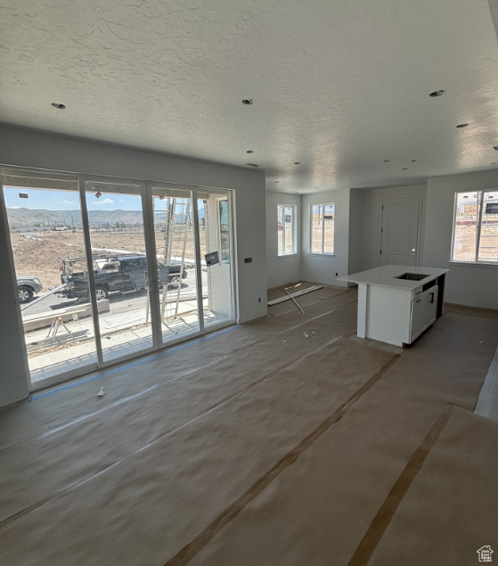 Unfurnished living room with a textured ceiling