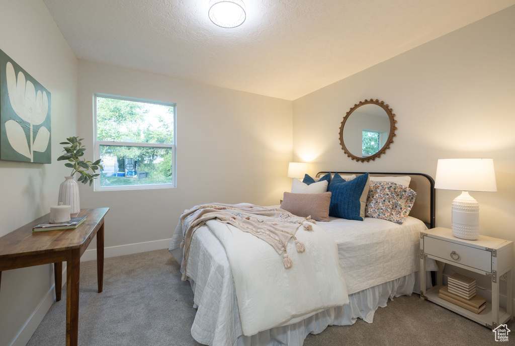 Carpeted bedroom featuring baseboards