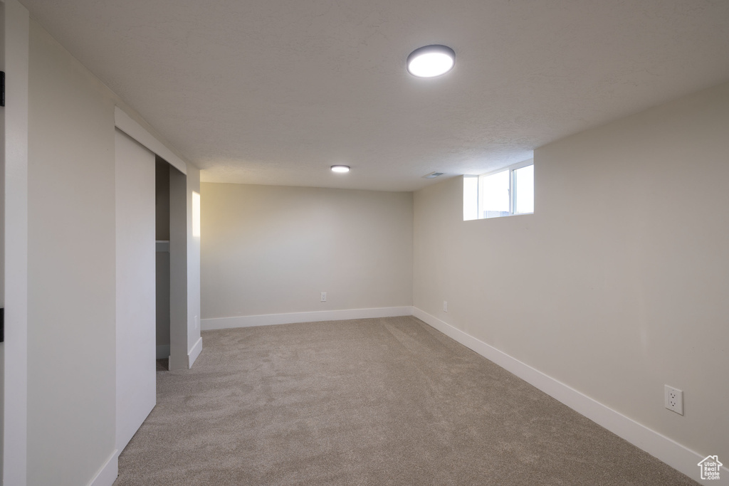 Below grade area featuring carpet floors and baseboards