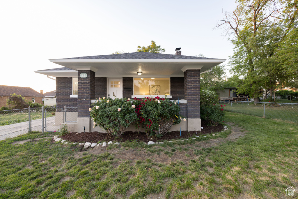 View of front of house with brick siding and a chimney