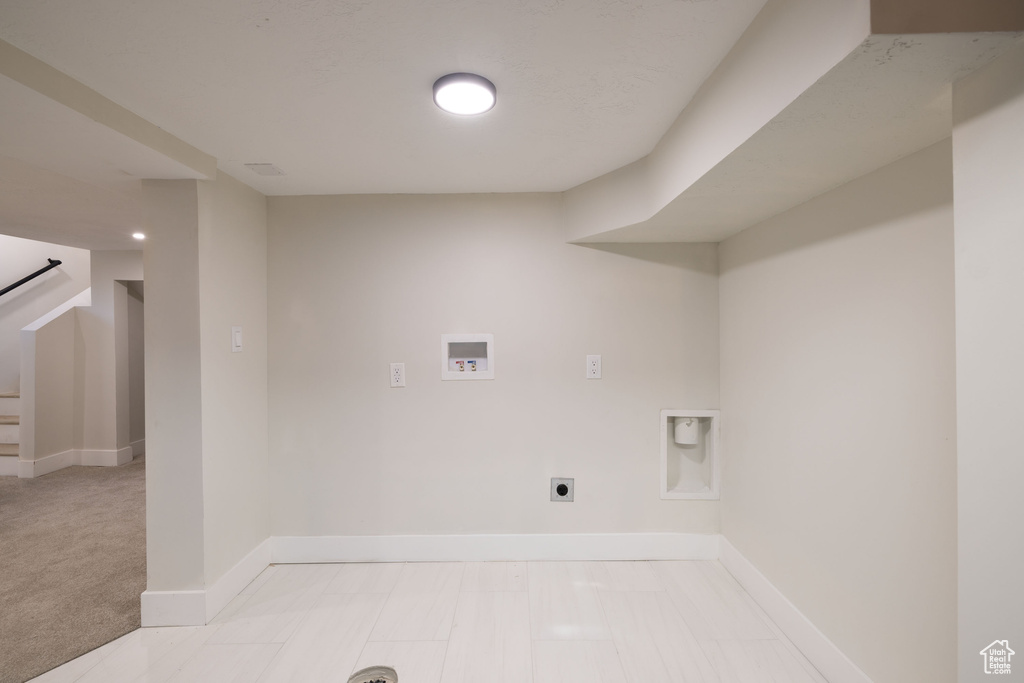 Washroom featuring electric dryer hookup, washer hookup, and baseboards