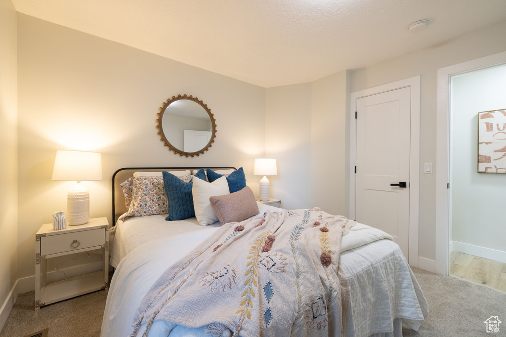 Bedroom featuring carpet floors and baseboards