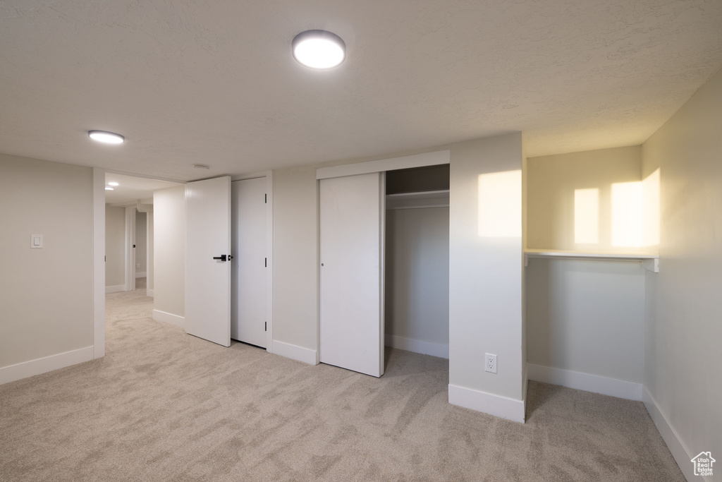 Unfurnished bedroom featuring carpet flooring and baseboards