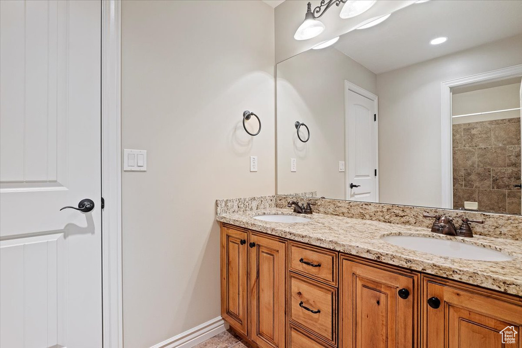 Bathroom featuring double vanity and a shower