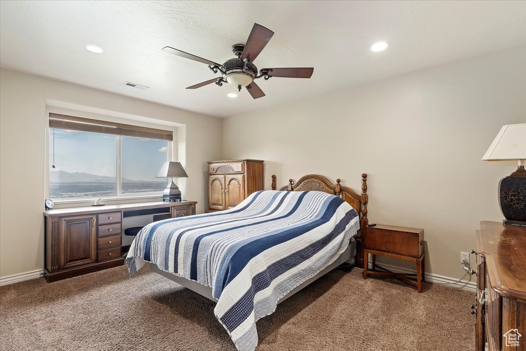 Carpeted bedroom with baseboards, recessed lighting, and ceiling fan