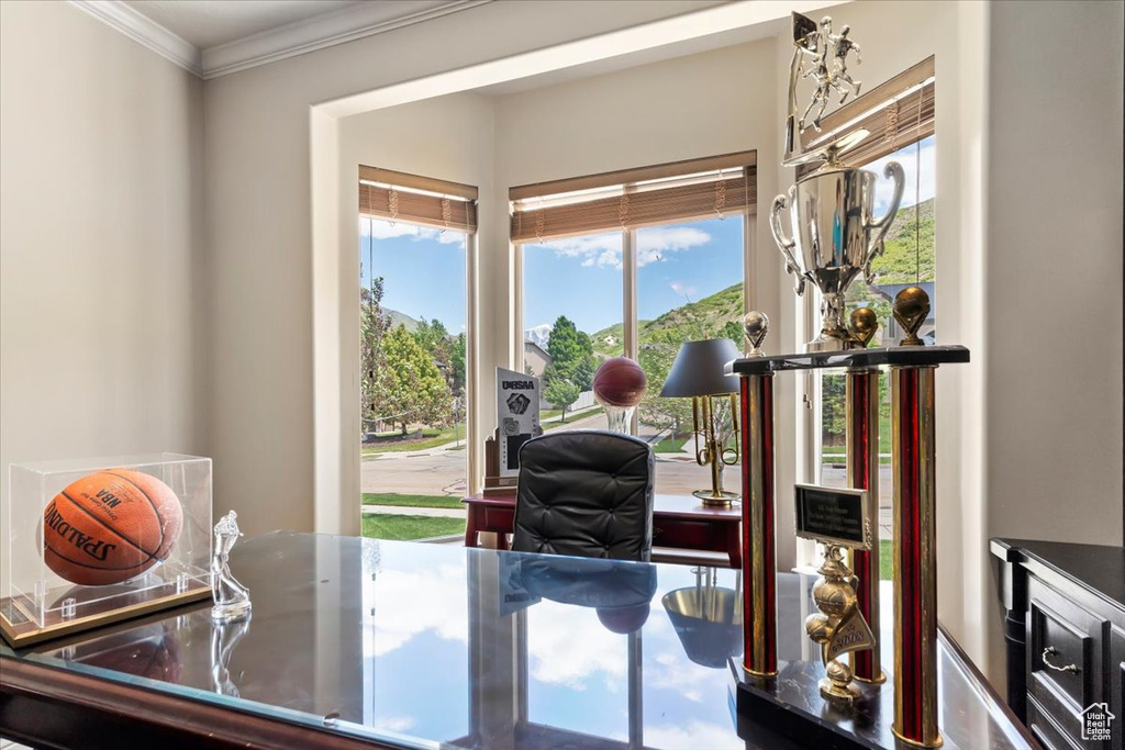 Dining area featuring ornamental molding and an office area