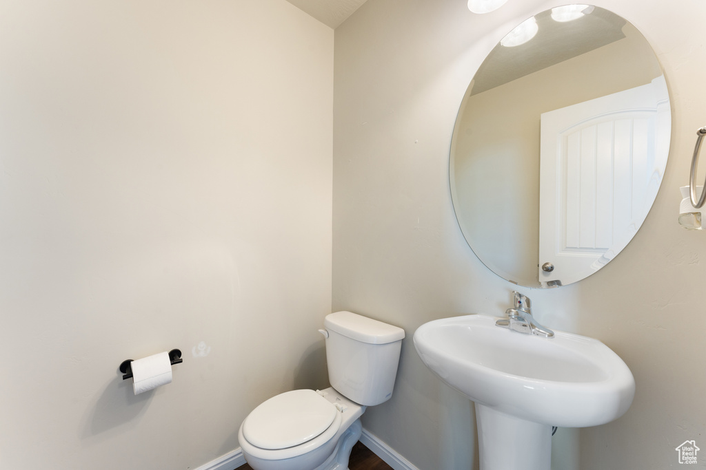 Bathroom with toilet and baseboards