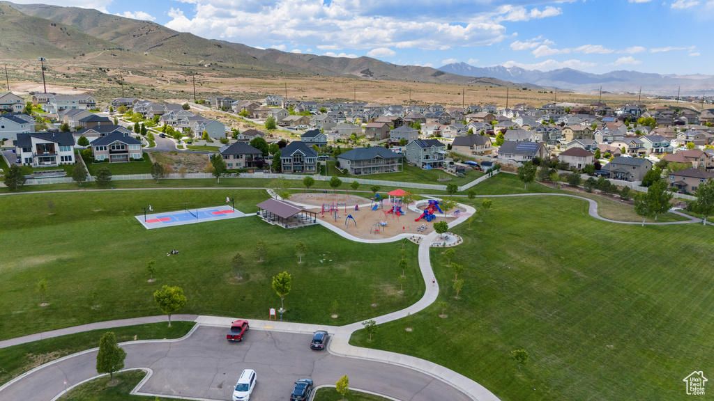 Aerial view of property's location with nearby suburban area and a mountain backdrop